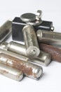 Waste batteries of different types are scattered. On a white background. Royalty Free Stock Photo