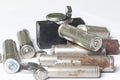 Waste batteries of different types are scattered. On a white background. Royalty Free Stock Photo