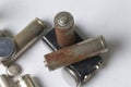 Waste batteries of different types are scattered. On a white background. Royalty Free Stock Photo