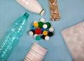 Waste, garbage from plastic bottles, glasses, egg packaging and lids on a blue background. Royalty Free Stock Photo