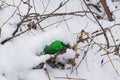 Waste, garbage, trash, under the snow in the forest. Littered nature Royalty Free Stock Photo