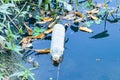 Waste from plastic bottle floating on water surface in river is a problem and water pollution in evening. Royalty Free Stock Photo