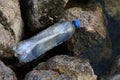 Waste plastic bottle at the river, Waste pollution, Garbage Trash plastic bottles empty on stone Royalty Free Stock Photo