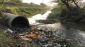 Waste and polluted water discharge through a sewage pipe into a canal, an environmental pollution concept Royalty Free Stock Photo