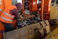 Waste processing factory in Firmat, Argentina with workers in orange vests handling large machines
