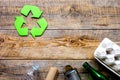 Waste recycling symbol with garbage on wooden background top view mock-up Royalty Free Stock Photo