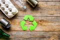 Waste recycling symbol with garbage on wooden background top view mock-up Royalty Free Stock Photo