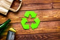 Waste recycling symbol with garbage on wooden background top view mockup Royalty Free Stock Photo