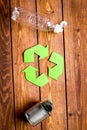 Waste recycling symbol with garbage on wooden background top view mockup Royalty Free Stock Photo