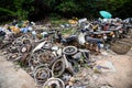 Waste scrap with engine motorcycle old rust ,heap of old rusty metal wheel rims in the car drum wheel vehicle waste Royalty Free Stock Photo