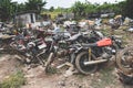 Waste scrap with engine motorcycle old rust ,heap of old rusty metal wheel rims in the vehicle waste Royalty Free Stock Photo