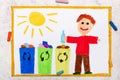 Waste separation. Smiling boy segregating their garbage to different colored trash bins.