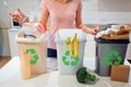 Waste sorting at home. Recycling. Woman putting plastic bottle in the garbage bin in the kitchen