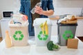 Waste sorting at home. Recycling. Man putting plastic bottle in the garbage bin in the kitchen Royalty Free Stock Photo