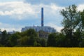 Waste-to-energy plant behind a rapeseed field in Frankfurt