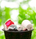 Wastebasket on green leaves