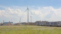 Wasteland in the harbor of Ghent, with windmills and parked trucks