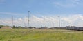 Wasteland in the harbor of Ghent, with windmills and parked trucks