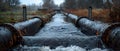 Wastewater pipes from industrial plants which is a large pipe made of metal. The wastewater flowing from the pipe is black and