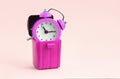 Wasting time concept. Alarm clock in trash bin