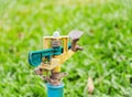 Wasting water - Water tap on green grass Royalty Free Stock Photo
