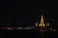 Wat Arun at night with gold and is the oldest temple of the Chao Phraya River. in Bangkok Thailand