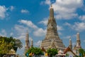 Wat Arun Ratchawararam with beautiful blue sky and white clouds. Wat Arun buddhist temple is the landmark in Bangkok, Thailand. Royalty Free Stock Photo