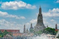 Wat Arun Ratchawararam with beautiful blue sky and white clouds. Wat Arun buddhist temple is the landmark in Bangkok, Thailand. Royalty Free Stock Photo