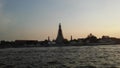 Wat Arun Ratchawararam Ratchawaramahawihan, Wat Arun, Temple of Dawn across Chao Phraya River during Sunset in Bangkok, Thailand. Royalty Free Stock Photo