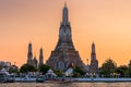 Wat Arun stupa, a significant landmark of Bangkok, Thailand, stands prominently along the Chao Phraya River, with a beautiful Royalty Free Stock Photo