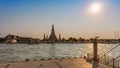 Wat Arun stupa, a significant landmark of Bangkok, Thailand, stands prominently along the Chao Phraya River, with an evening sky Royalty Free Stock Photo