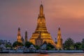 Wat Arun stupa, a significant landmark of Bangkok, Thailand, stands prominently along the Chao Phraya River, with a beautiful Royalty Free Stock Photo