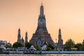 Wat Arun stupa, a significant landmark of Bangkok, Thailand, stands prominently along the Chao Phraya River, with a beautiful Royalty Free Stock Photo