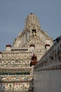 Wat Arun temple tower and a fragment of the temple wall Royalty Free Stock Photo