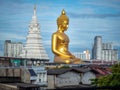 Wat Paknam Phasi Charoen temple in Bangkok, Thailand, with a golden buddha statue in the foreground