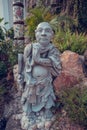 Wat Pho chinese monk stone statue. Bangkok, Thailand.