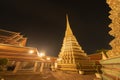 Wat Phra Chetuphon or Wat Pho, a Buddhist temple illuminated at night in Bangkok City, Thailand. Thai architecture buildings Royalty Free Stock Photo