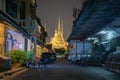 Wat Phra Chetuphon or Wat Pho, a Buddhist temple illuminated at night in Bangkok City, Thailand. Thai architecture buildings Royalty Free Stock Photo