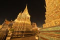 Wat Phra Chetuphon or Wat Pho, a Buddhist temple illuminated at night in Bangkok City, Thailand. Thai architecture buildings Royalty Free Stock Photo