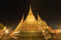 Wat Phra Chetuphon or Wat Pho, a Buddhist temple illuminated at night in Bangkok City, Thailand. Thai architecture buildings Royalty Free Stock Photo