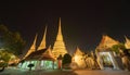 Wat Phra Chetuphon or Wat Pho, a Buddhist temple illuminated at night in Bangkok City, Thailand. Thai architecture buildings Royalty Free Stock Photo