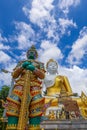 Mae Hia,Chiang Mai,Northern Thailand on Septemmber 13,2019:Demon guardian statue and Sitting Buddha Statue at Wat Phra That Doi