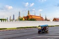 Wat Phra Kaew in Bangkok, Thailand and Tuk Tuk is on the road : Royalty Free Stock Photo