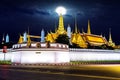 Wat phra keaw with full moon at night in Bangkok.