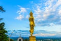 Wat Phra That Khao Noi, Nan Province, Thailand, Golden Buddha statue standing on a mountain Royalty Free Stock Photo