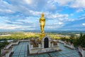 Wat Phra That Khao Noi, Nan Province, Thailand, Golden Buddha statue standing on a mountain Royalty Free Stock Photo