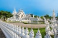Wat Rong Khun The White Abstract Temple and pond with fish, in Chiang Rai, Thailand.