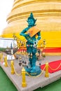 Wat Saket temple with golden stupa and angel statue. Symbol of buddhism in Bangkok city, Thailand. Majestic and religion symbol of Royalty Free Stock Photo