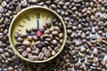 Watch face with Roman numerals on the background of coffee beans. Royalty Free Stock Photo