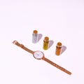 Watch and glitter bottles in white space. New Year, holiday, Christmas concept. Minimalism, fashion Still life scene